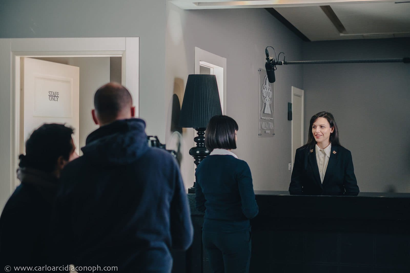 A concierge at the desk during filming