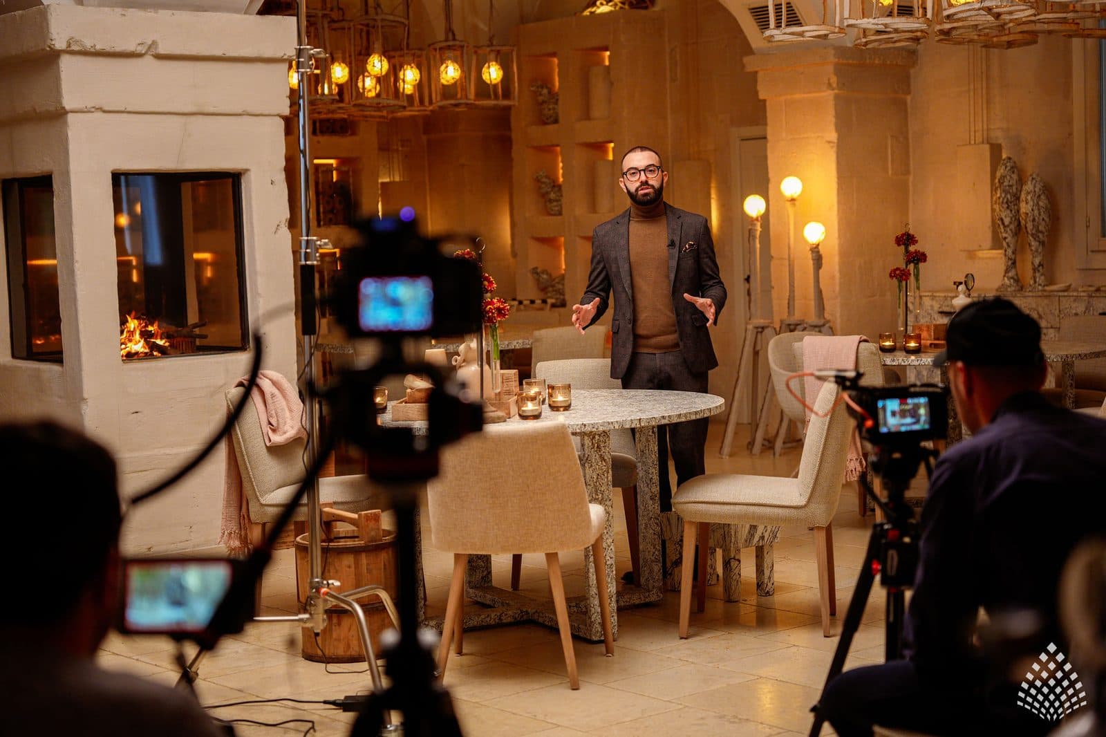 The set lit for filming in a dining room at Borgo Egnazia