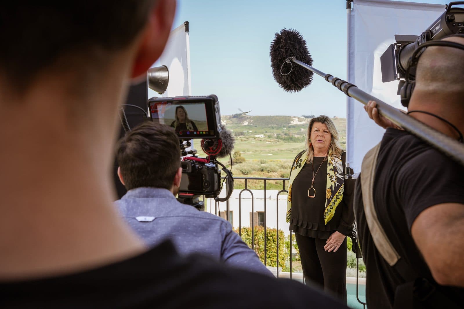 A presenter being filmed on the terrace at Verdura Resort