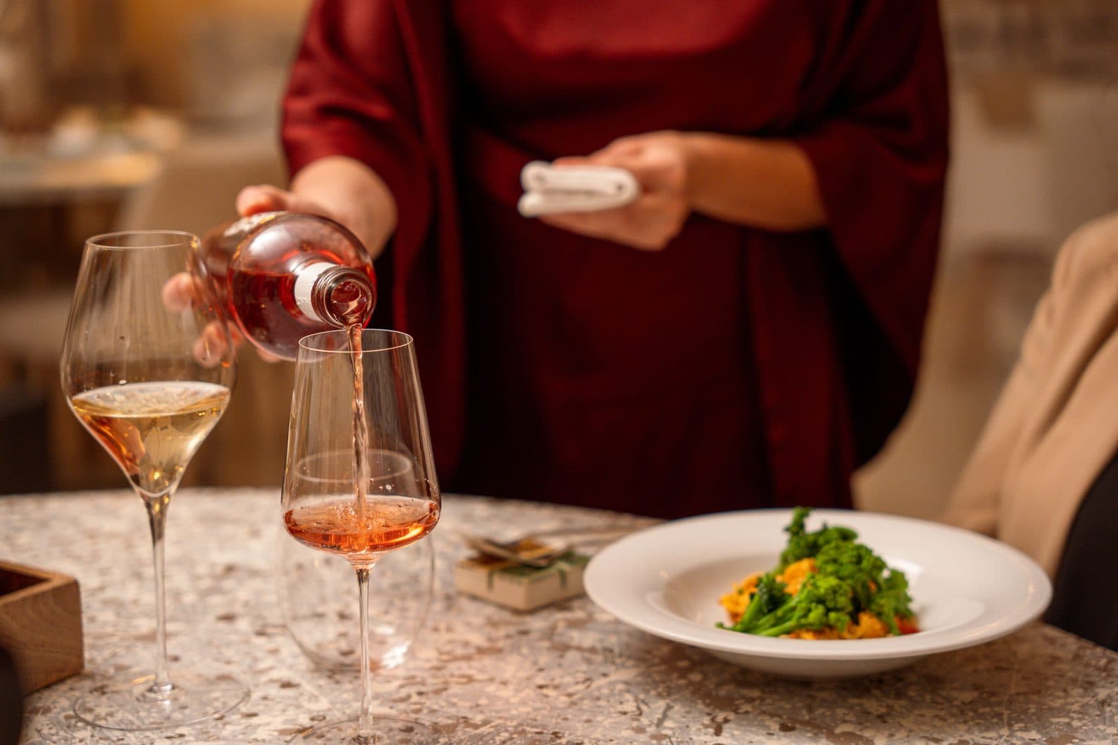 Rosé poured beside a plated dish at Borgo Egnazia