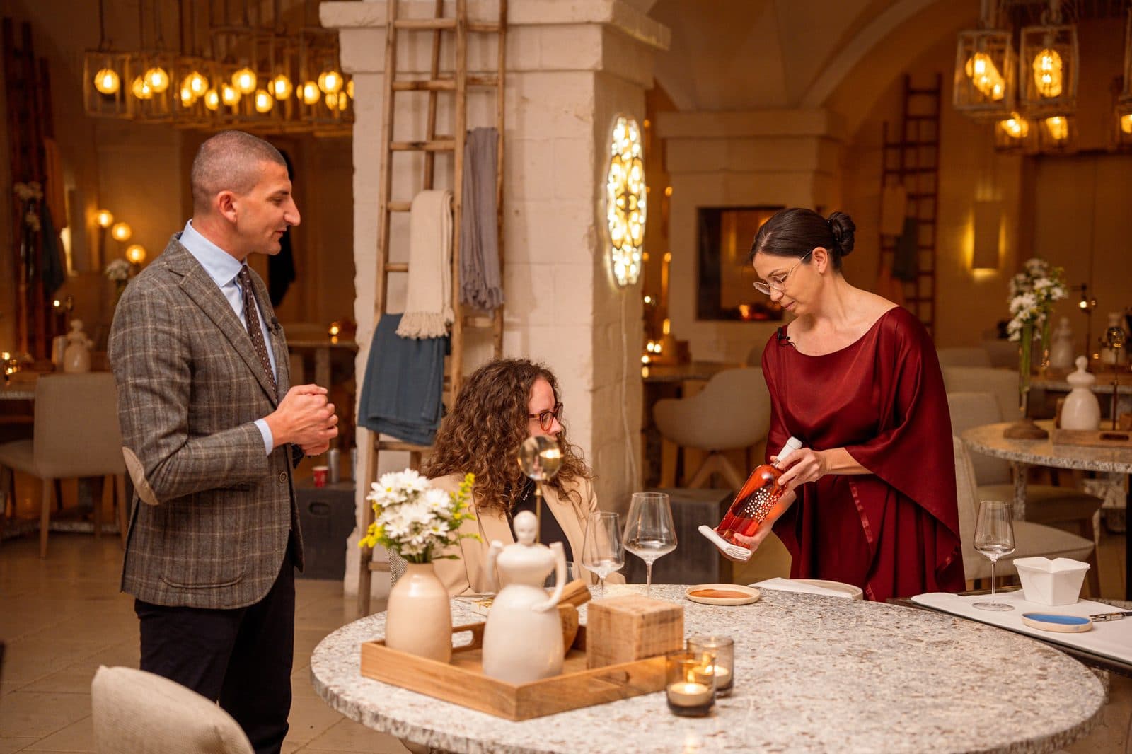 A sommelier serving wine at the table at Borgo Egnazia