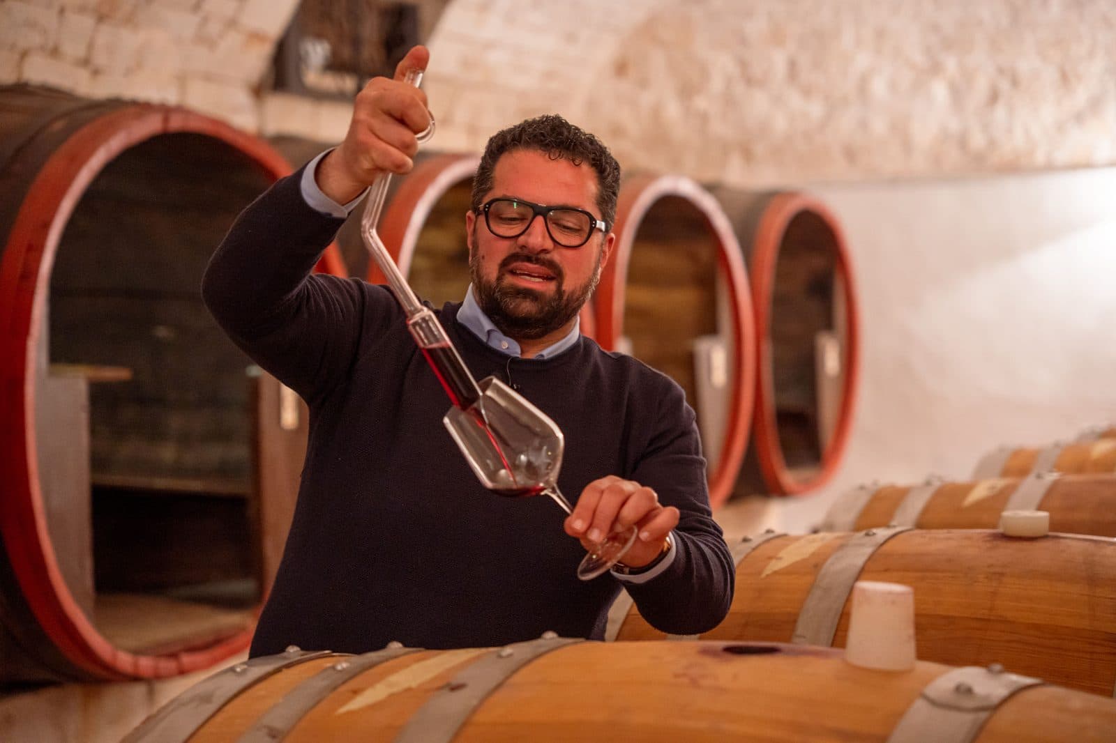 Wine being decanted above the barrels at Borgo Egnazia