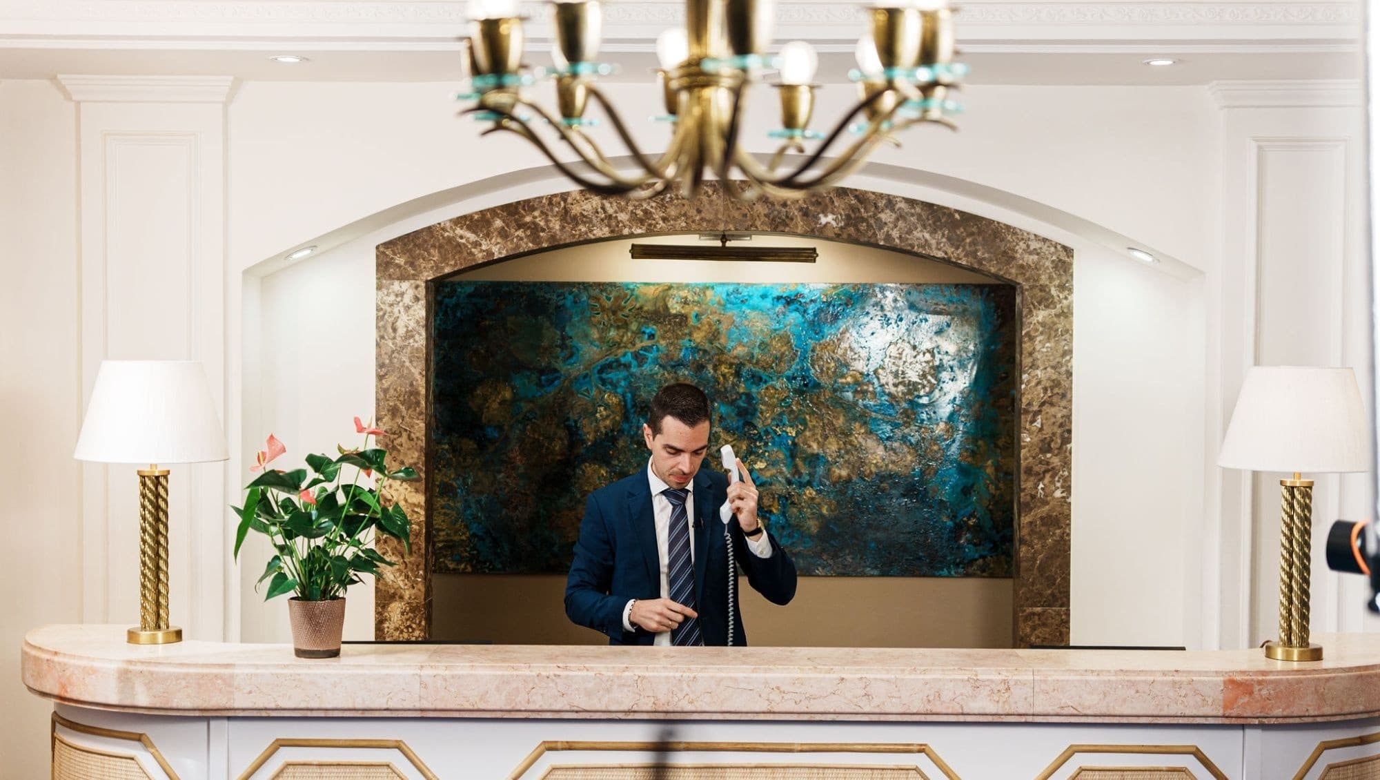 The front office manager of Villa Sant'Andrea at the reception desk