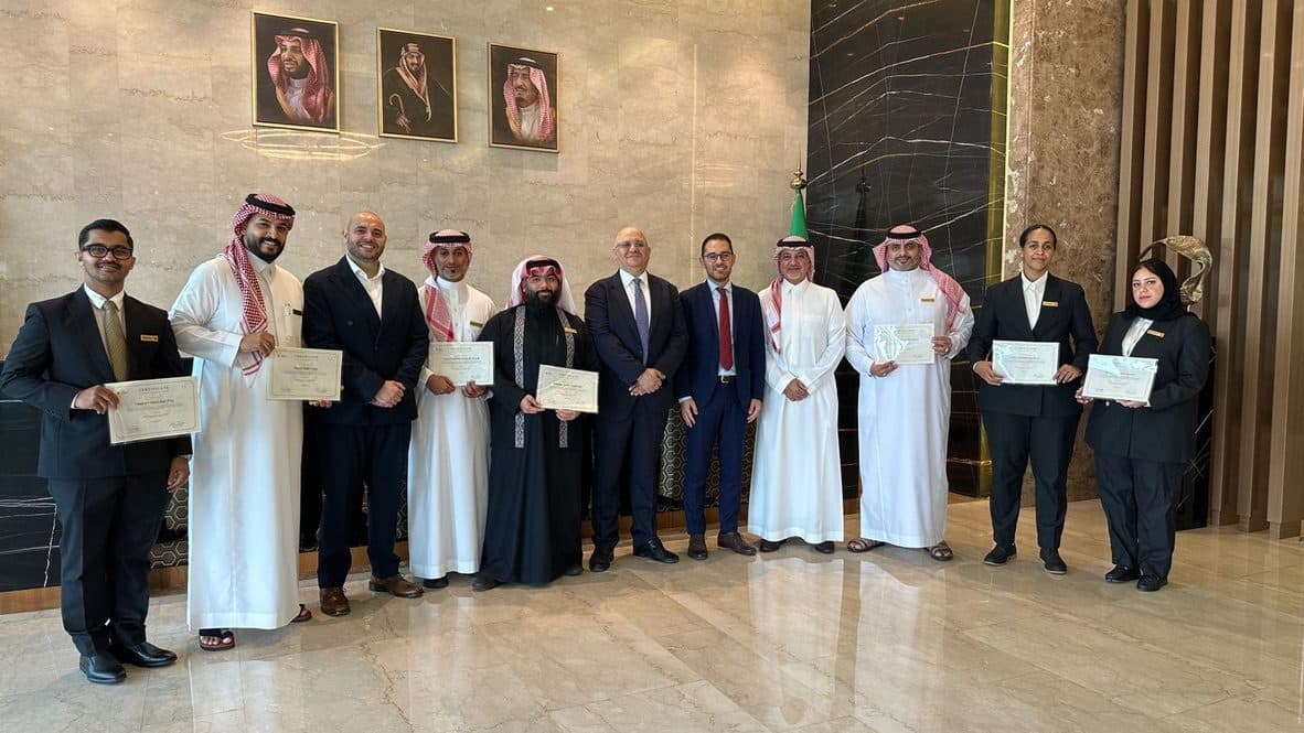 A group of hospitality professionals with their course certificates